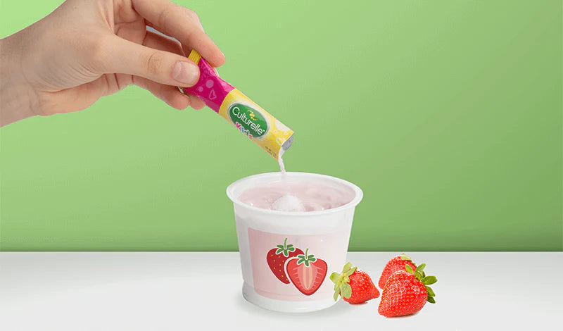 kids packet pouring into strawberry yogurt