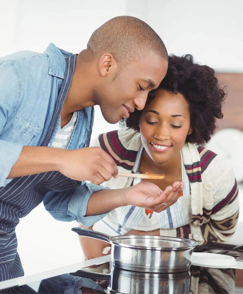 man and woman cooking food