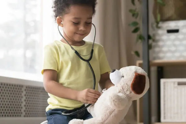 girl listening to stuffed animal bear heartbeat